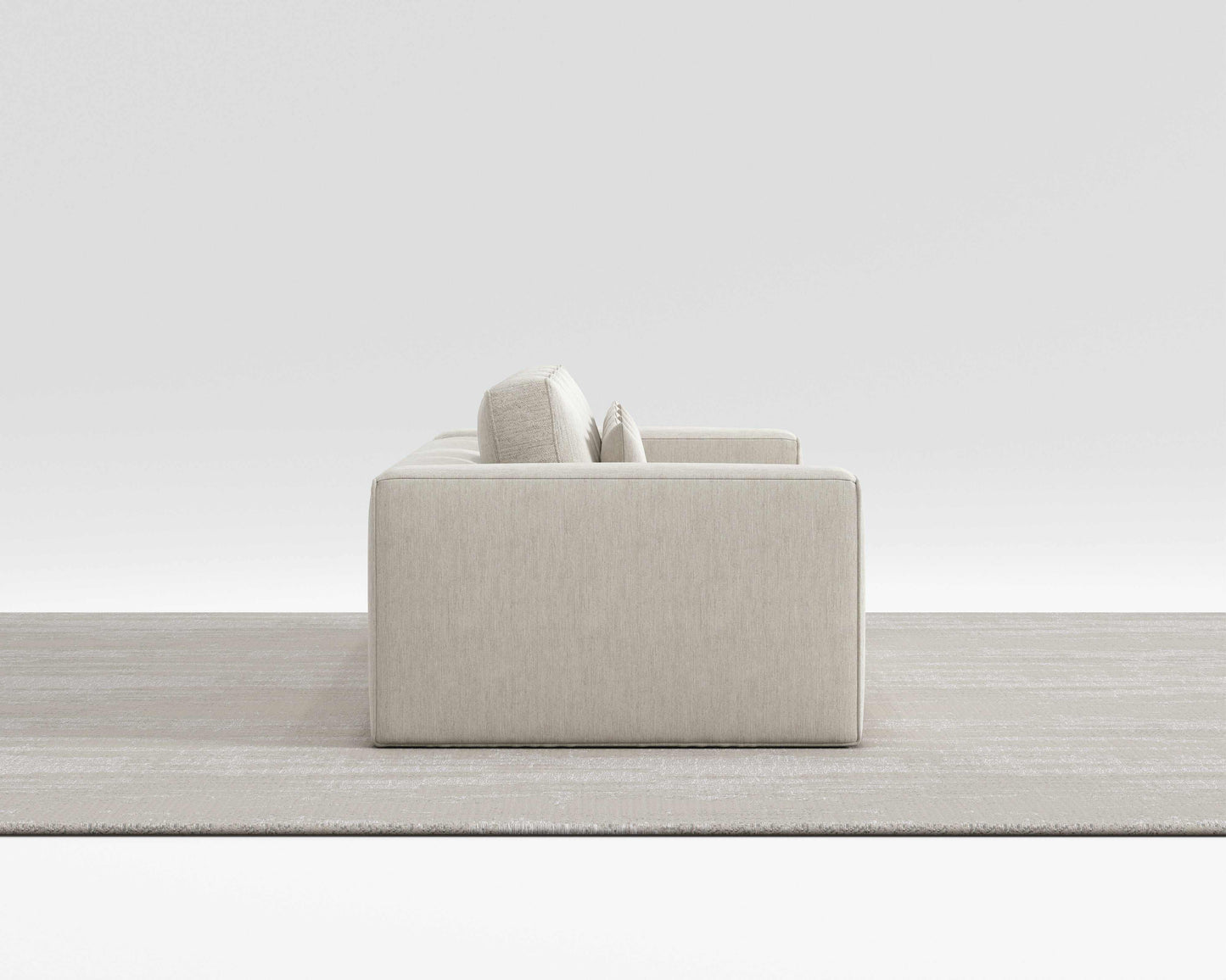 HAVEN SOFA with minimalist design and modern square pillows in a sleek, modern room setting.