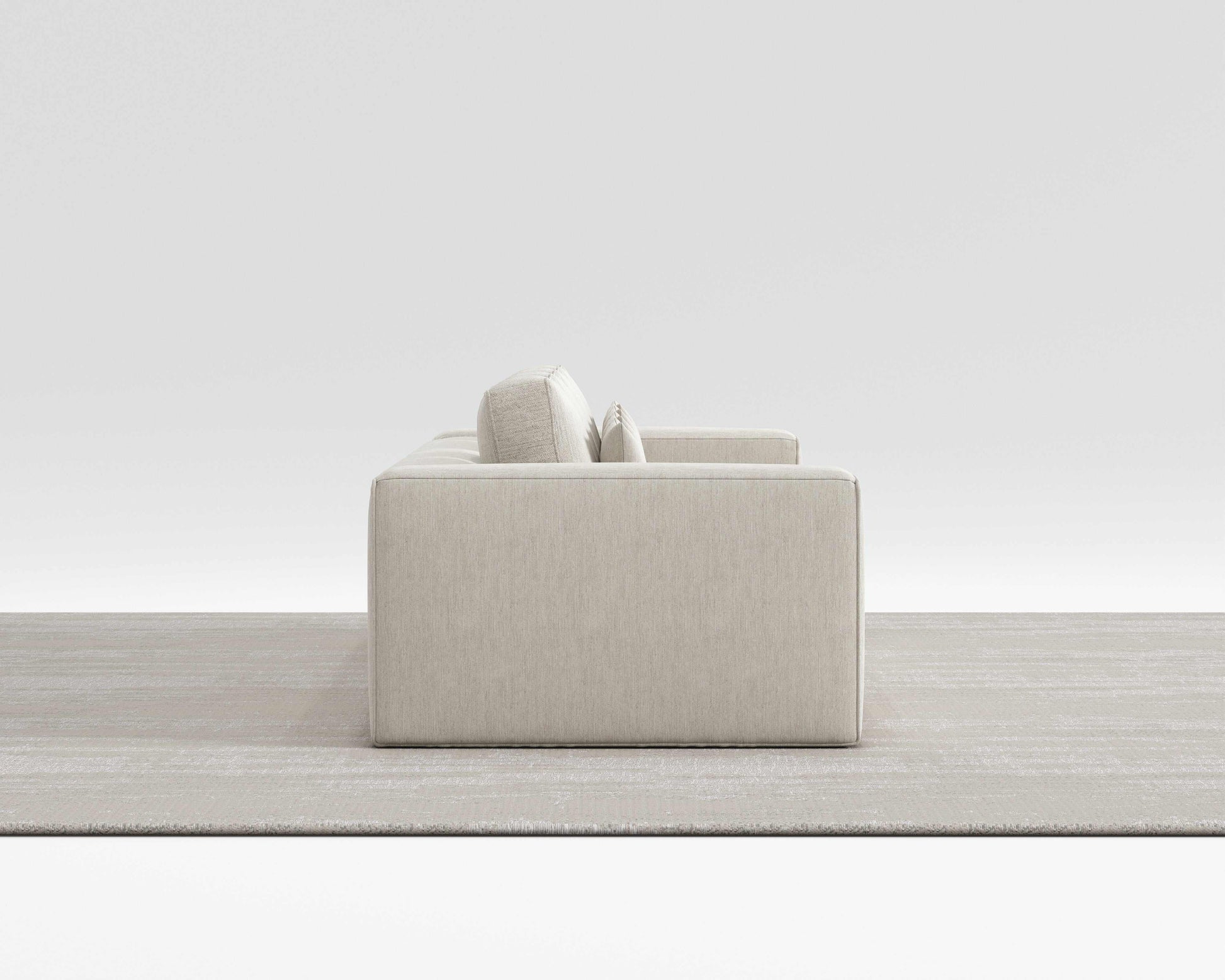 HAVEN SOFA with minimalist design and modern square pillows in a sleek, modern room setting.