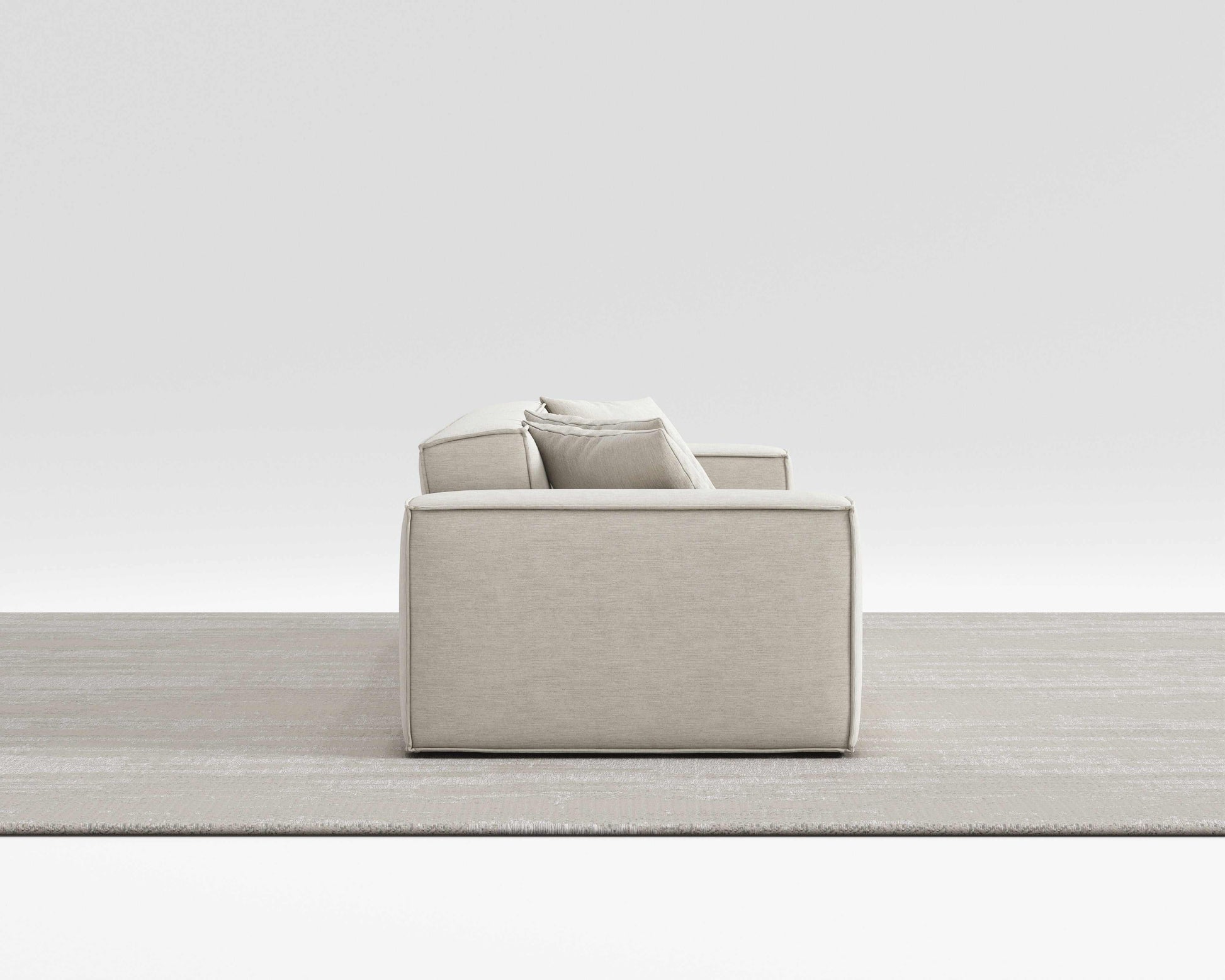 BLISS SOFA side view with minimalist design, vegan performance weave upholstery, and pillow on armrest.