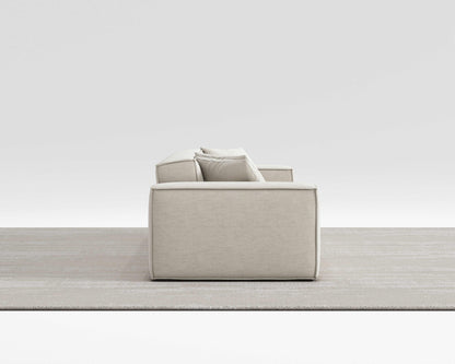 BLISS SOFA side view with minimalist design, vegan performance weave upholstery, and pillow on armrest.