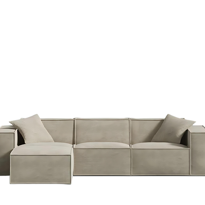 Modern sand-colored sectional sofa with sleek design and comfy armrest pillows.